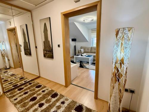 a living room with a hallway with a mirror at Lambada Penthouse in Bugojno