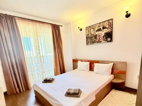 a hotel room with a bed and a window at Apartament Centru Plaja Modern in Constanţa