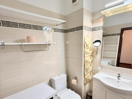 a bathroom with a white toilet and a sink at Apartament Centru Plaja Modern in Constanţa
