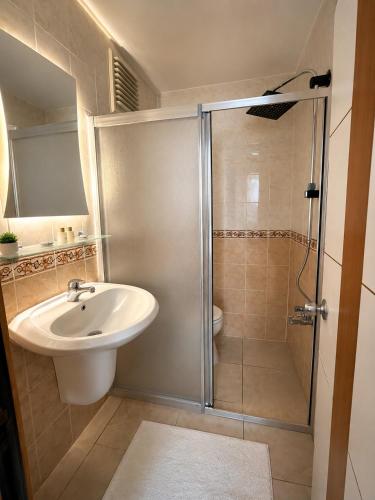 a bathroom with a sink and a shower at OTEL MOLA BALIKESiR in Balıkesir