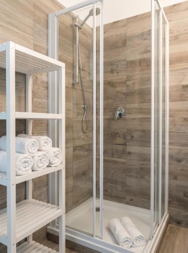 a bathroom with a shower and some towels at Casa Panorama Intelvi - Como & Lugano Lakes in Laino