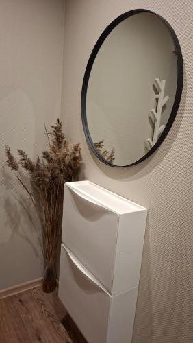 a mirror on a wall next to a white refrigerator at Border Madise Apartment, Madise tn 8, Apt 7, Narva in Narva