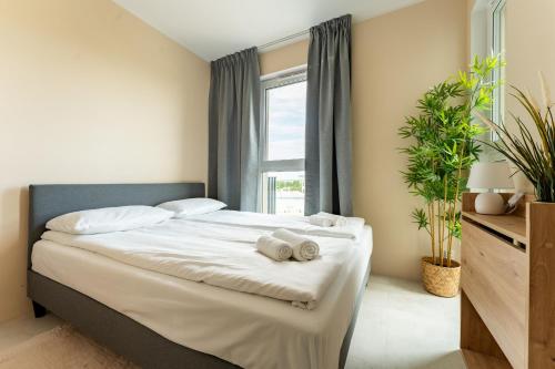 a bedroom with a bed with towels on it at Rumia Stylish Apartment by BookingHost in Rumia