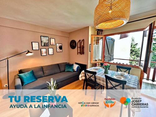 a living room with a couch and a table at Apartamentos Confort Formigal 3000 in Formigal