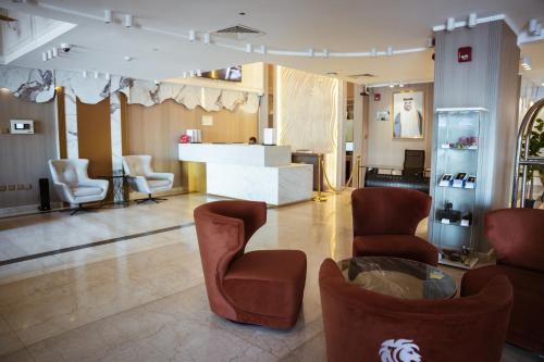 a lobby with chairs and a counter in a store at Al Mansour Plaza Hotel in Doha