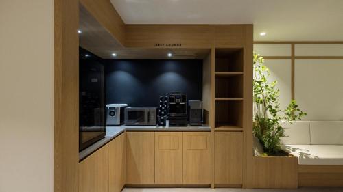 a kitchen with a counter with a microwave at Anook Ryokan Hotel Suwon Ingye in Suwon