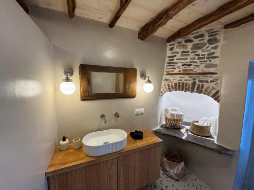 a bathroom with a sink and a mirror at NeSi Cycladic Living in Ano Syros