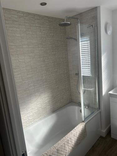 a bathroom with a shower with a glass door at House of Berry in EDI