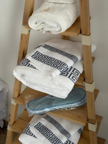 a wooden towel rack with towels on it at 13th private in Rueil-Malmaison