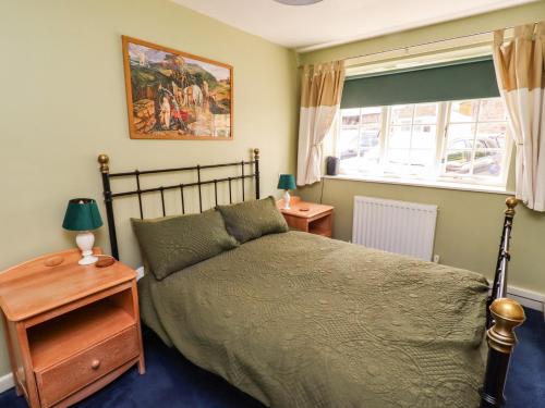 a bedroom with a bed and a window and a bed sidx sidx sidx at Flodden Apartment in Wooler