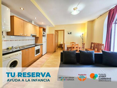 a living room with a couch and a kitchen at Apartamentos Canfranc 3000 in Canfranc-Estación