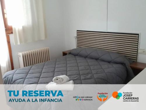 a bedroom with a bed with towels on it at Apartamentos 3000 Formigal in Formigal