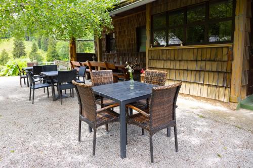 a table and chairs sitting outside of a cabin at Alpine Lodge Goška Ravan in Radovljica