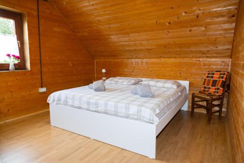 a bedroom with a bed in a wooden room at Alpine Lodge Goška Ravan in Radovljica