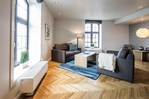 a living room with a couch and a table at Thon Hotel Victoria Hamar in Hamar