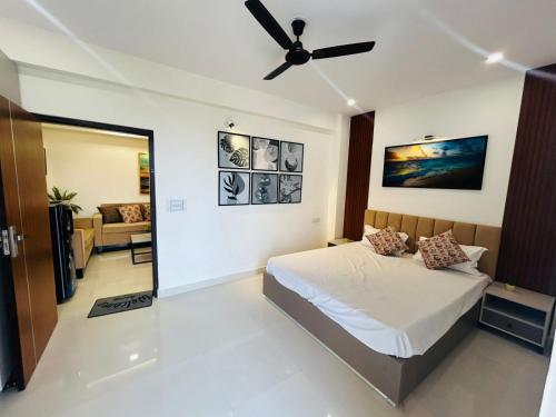 a bedroom with a bed and a ceiling fan at Phool Ghar by Hrittika in Siroli