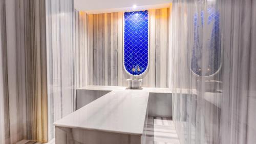 a bathroom with a white sink and a window at Çenger Blue Collection Hotel Ultra All Inclusive in Manavgat