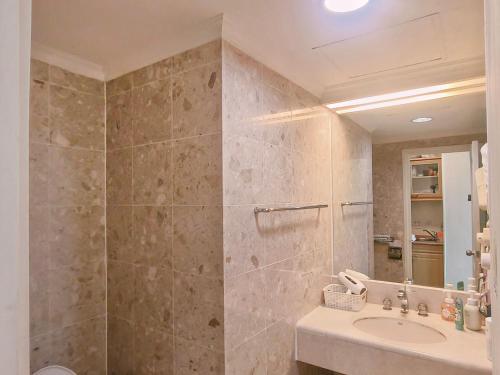 a bathroom with a sink and a shower at Niwill Homestay in Taichung