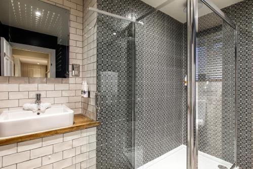 a bathroom with a sink and a shower at The Bull in Ditchling