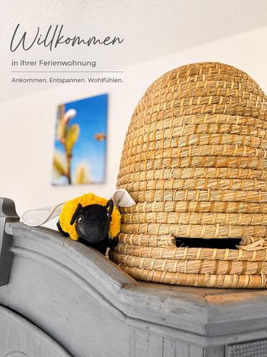 a stuffed animal is laying on top of a basket at Ferienwohnung Bienenkörbchen in Barge