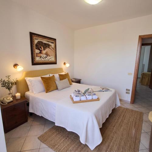 a bedroom with a large white bed with a tray on it at Casa Stella in Sarnano