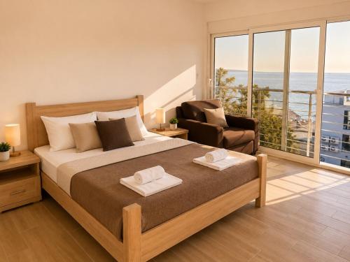 a bedroom with a bed and a chair and a large window at Apart-Hotel Saraj in Dobra Voda