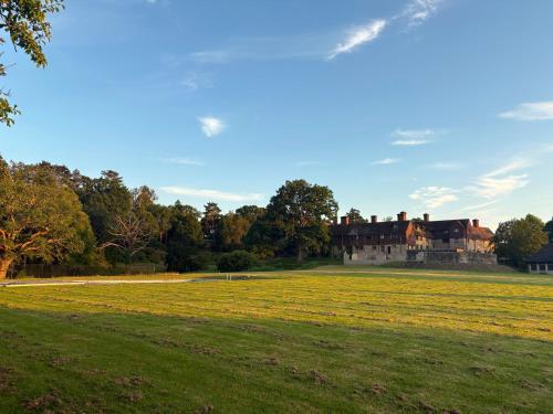 a large house in the middle of a field at Glamping Fit in the wild in Forest Row