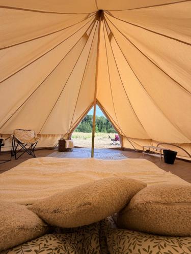 a large tent with a bed in front of it at Glamping Fit in the wild in Forest Row