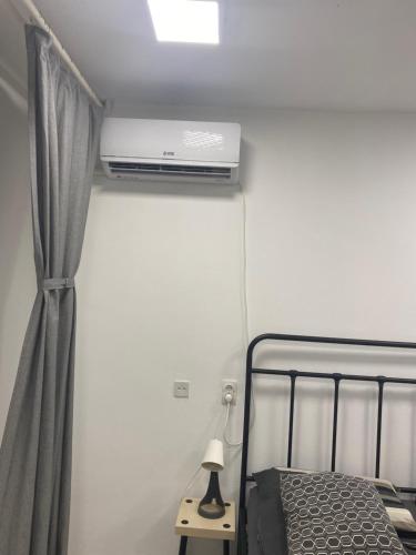 a bedroom with a bed with a air conditioner on the ceiling at Dona1102 in Žarkovo