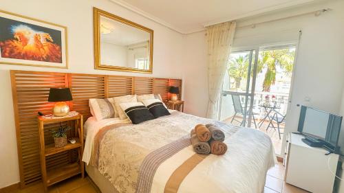a bedroom with a bed with two donuts on it at NEW Villa Cabo Roig Coco-Mat 2 in Playas de Orihuela