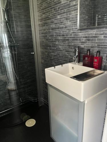 a bathroom with a white sink and a shower at Villa Martini in Åmål