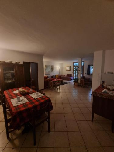 a living room with a table and a couch at La Casa Dei Boschi in San Marino