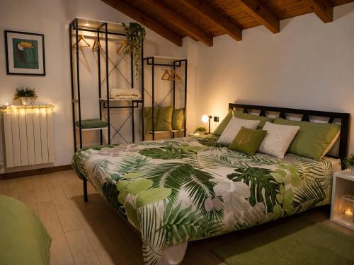 a bedroom with a large bed with a green comforter at Lilly House Perfect stopover near Lake Como Switzerland and Milan in Fino Mornasco