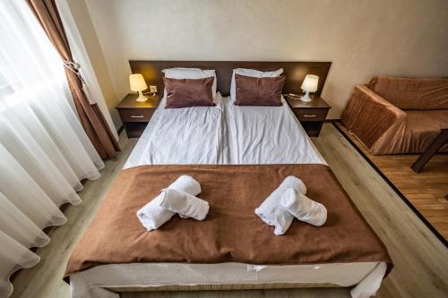 a bedroom with two towels on a bed at Snow Crystal Studio in Bansko