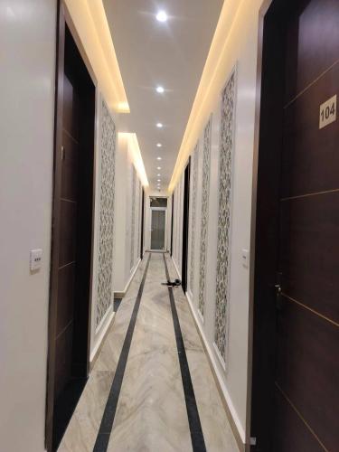 a hallway of a building with doors and a tile floor at Savadhani Palace in Govardhan