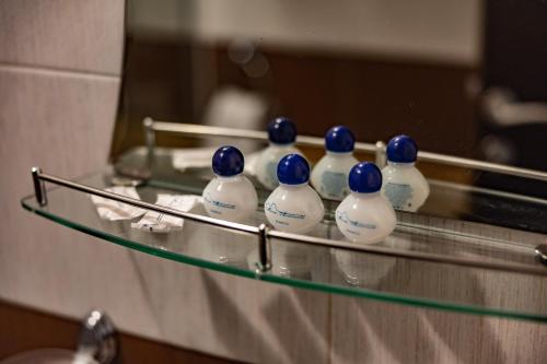 a glass shelf with a bunch of blue bottles on it at Snow Crystal Studio in Bansko