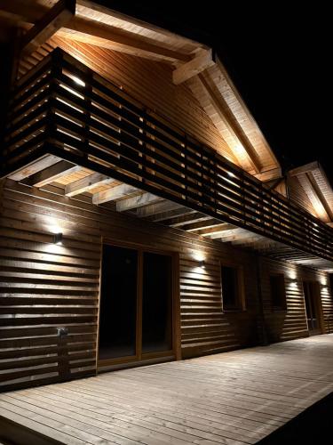 a wooden building with a balcony with lights on it at Bergliebe Klippitztörl in Klippitztorl