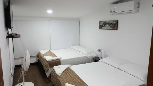 a hospital room with two beds and a television at Beach Paradise Apartments in San Andrés