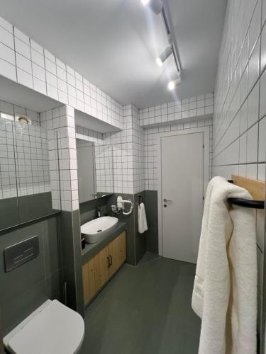 a bathroom with a white toilet and a sink at Summer Dream Escape Apartment in Gerakini
