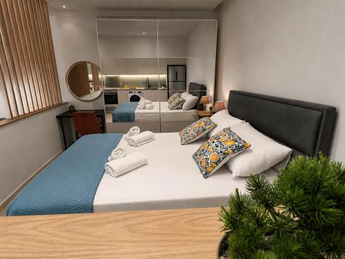 a bedroom with a large bed with towels on it at Summer Dream Escape Apartment in Gerakini