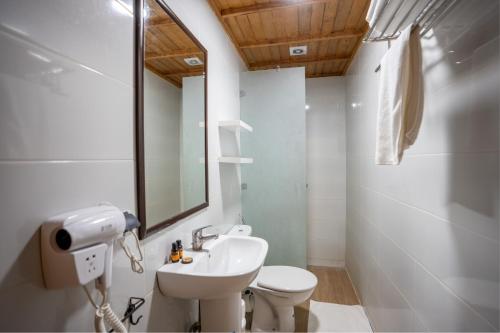 a bathroom with a sink and a toilet and a mirror at Dar Zayane in Khenifra