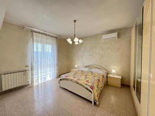 a bedroom with a bed and a large window at Mare e Monti a 5 minuti dal mare in Furnari
