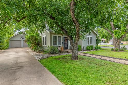 a house with a tree in front of a driveway at Beverly Haus in Fredericksburg