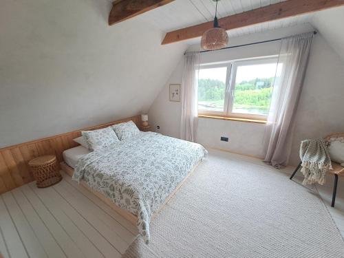 a bedroom with a bed and a window at Tuule in Jeedasküla