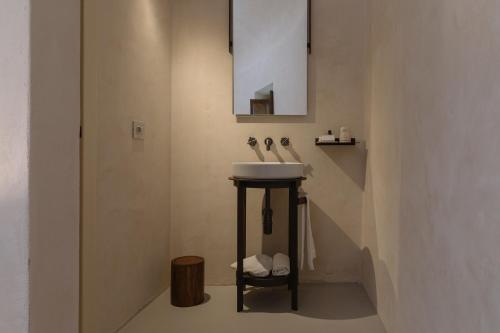 a bathroom with a sink and a stairway at Castel Di Luco - Authentic 11th-Century Castle in Acquasanta Terme