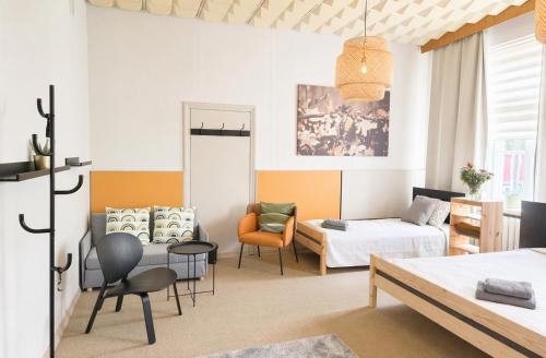 a bedroom with a bed and a living room at Pasta Kvartāls Inn in Ogre