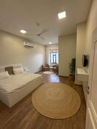 a bedroom with a bed and a living room at فيلا الريف in Kusāt