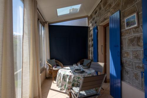 a dining room with a table and chairs and a window at My Alba in Jaujac