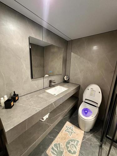 a bathroom with a toilet and a sink and a mirror at Vila Summer Depo in Sarandë