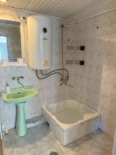 a bathroom with a sink and a bath tub and a sink at Гостевой Дом на природе in Vanadzor
